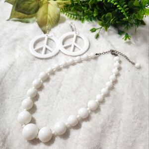 White Peace sign earrings and a matching white plastic necklace